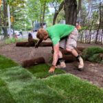 Our crew member Jason laying down the sod