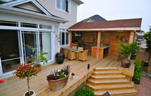Large deck with outdoor kitchen, bar and eating area