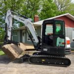 Installing 4000lbs natural stone step with excavator